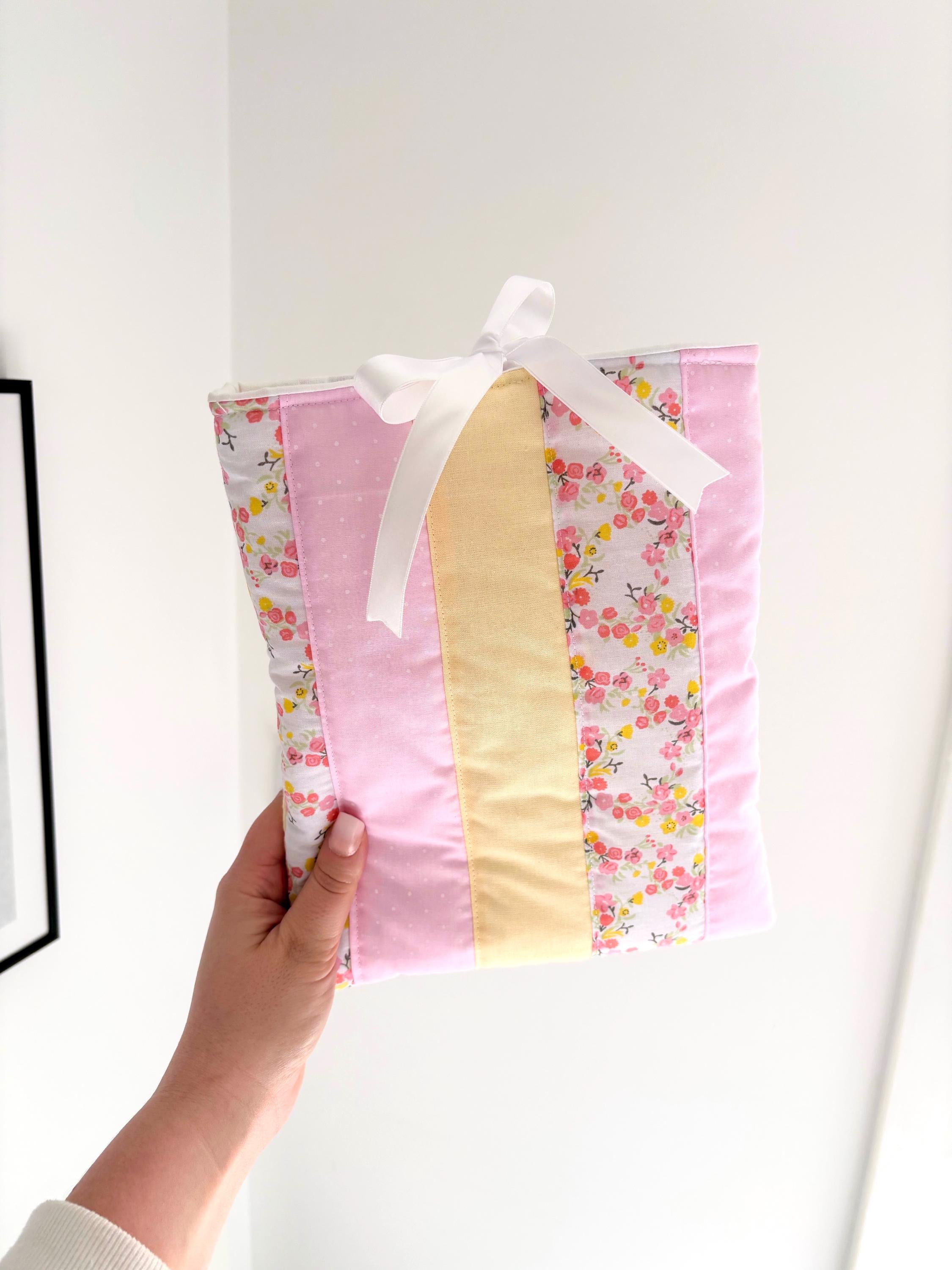 Pastel pink and yellow patchwork quilted book sleeve
